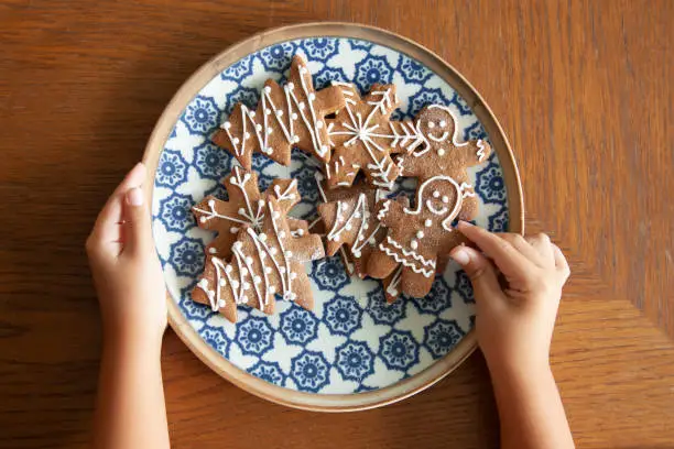 Delicious Christmas gingerbread ,star, tree, snow shaped cookies on white grunge wooden table.