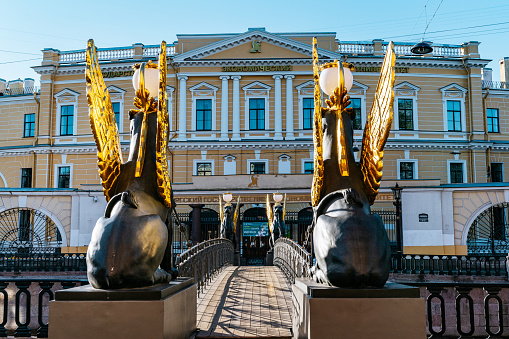Saint Petersburg, Admiralteisky district - Bridge in Saint Petersburg ornate with Black lions statues with golden wings.