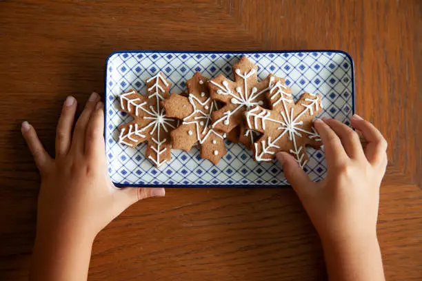 Delicious Christmas gingerbread ,star, tree, snow shaped cookies on white grunge wooden table.