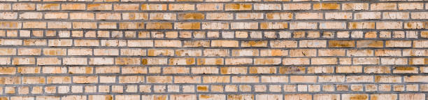 istock Panorama of the old yellow bricks wall, background 1285919437