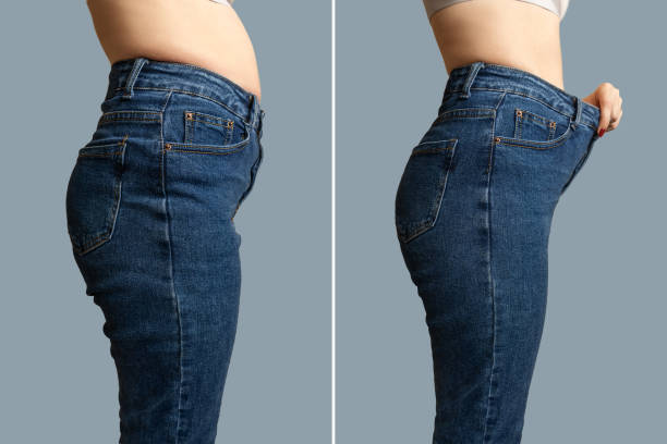 Female body before and after weight loss. Female body before and after weight loss, diet concept. Woman is measuring waist. Belly and legs in jeans close-up. before and after weight loss stock pictures, royalty-free photos & images