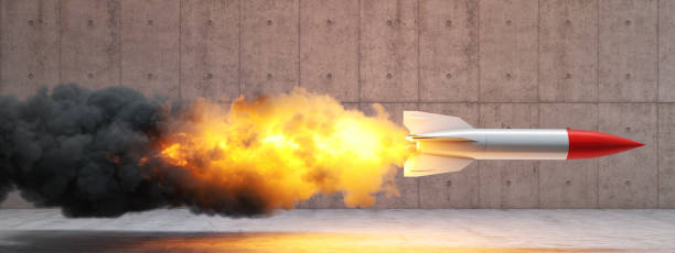istock rocket with flames and smoke on a concrete background. 1285921587