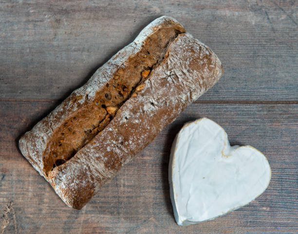 istock a French Neufchatel cheese shaped heart on wooden background 1285924471