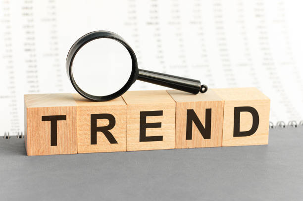 istock Wooden Blocks with the text: trend with magnifying glass. 1285925692