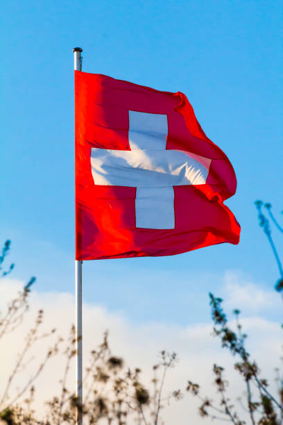 Switzerland national flag Swiss Confederation, Switzerland national flag waving on blue sky background, CH consul photos stock pictures, royalty-free photos & images