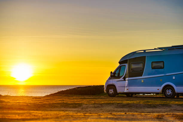 istock Camper car on beach at sunrise 1285927472
