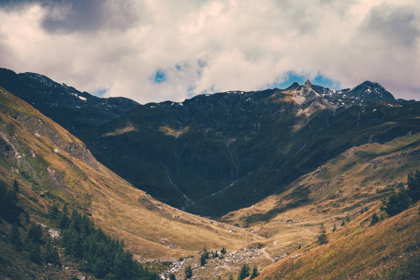 istock Mountain landscape - peaks in the clouds against the blue sky. 1285928766