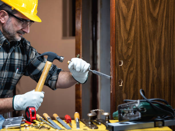 istock Carpenter at work repairs and installs the door lock. Carpentry. 1285929227