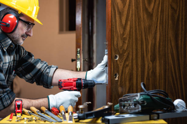 istock Carpenter at work repairs and installs the door lock. Carpentry. 1285929233