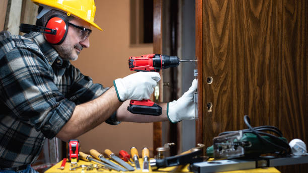 istock Carpenter at work repairs and installs the door lock. Carpentry. 1285929242