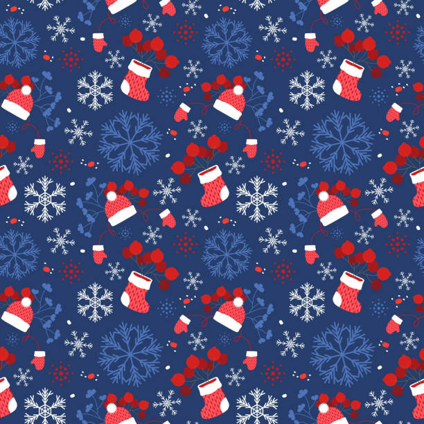 Knitted boots, mittens and a cap with snowflakes and berries, blue.