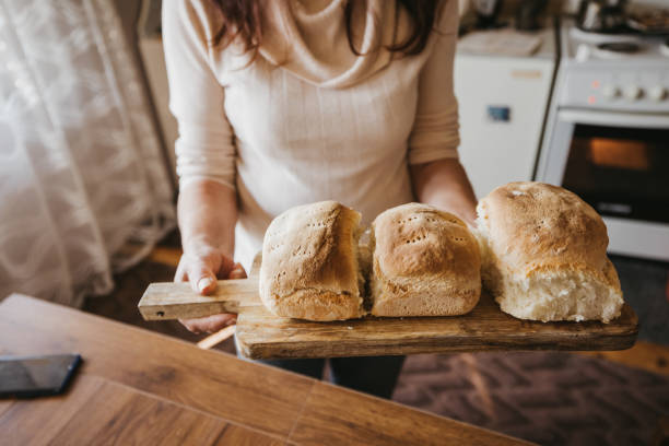 istock Senior woman holding freshly baked bread 1285929822