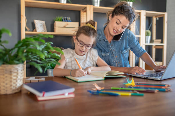 istock Woman working from home and her daughter doing homework 1285929960