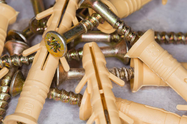 istock Cross recessed tapper screws with appropriate plastic anchors, closeup 1285930009