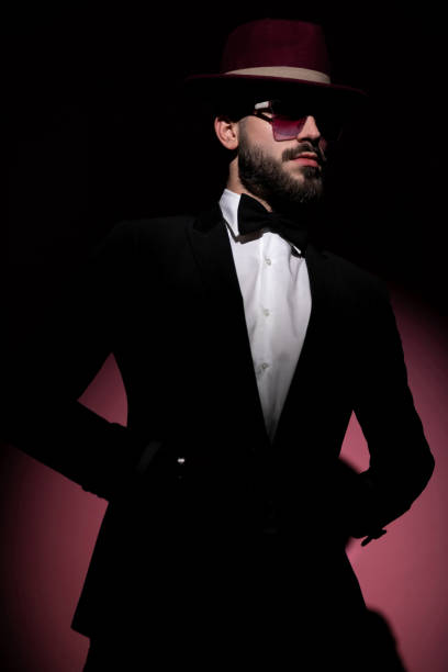istock cool mysterious businessman unbuttoning his jacket, looking away 1285930571
