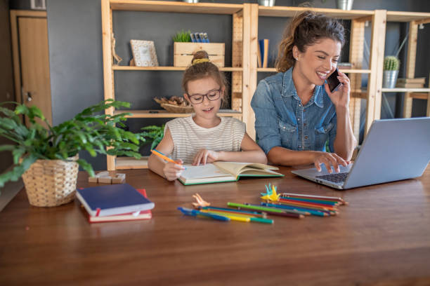 istock Woman working from home and her daughter doing homework 1285930604