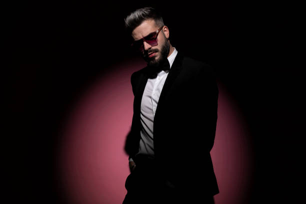 istock attractive businessman posing against pink background 1285930726