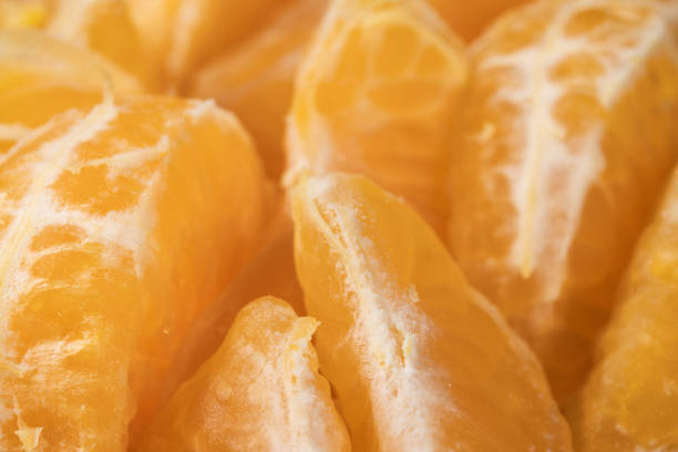 Peeled mandarin slices close-up. Ingredient for fruit salad.