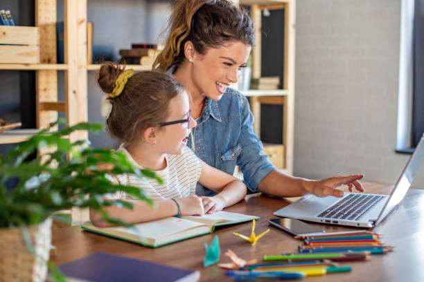 istock Woman working from home and her daughter doing homework 1285930781