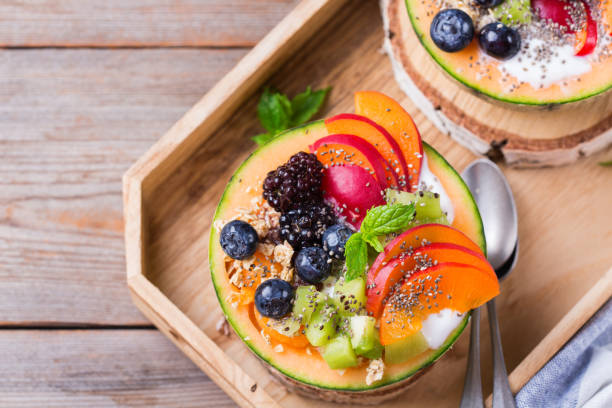 istock Fruit salad with yogurt in carved melon cantaloupe bowl 1285932818