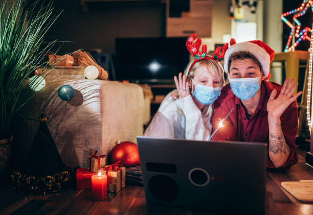 Couple Celebrating Christmas And New Year's Eve At Home Using Technology