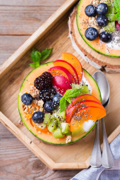 istock Fruit salad with yogurt in carved melon cantaloupe bowl 1285932851