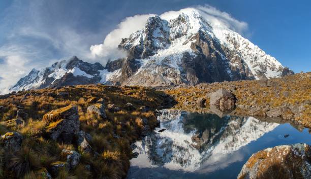 Evening mount Salkantay or Salcantay and lake in Peru Evening view of mount Salkantay mirroring in lake, Salkantay trek in the way to Machu Picchu, Cuzco area in Peru Sallqantay stock pictures, royalty-free photos & images