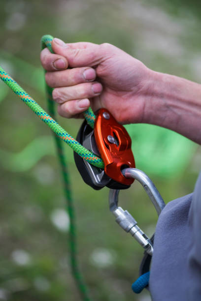 istock Man's hands operating a rock climbing belaying device 1285936553
