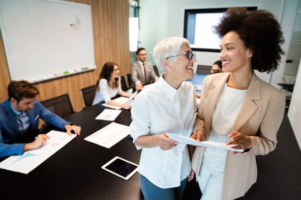 istock Group of business partners discussing documents and ideas at meeting 1285936663