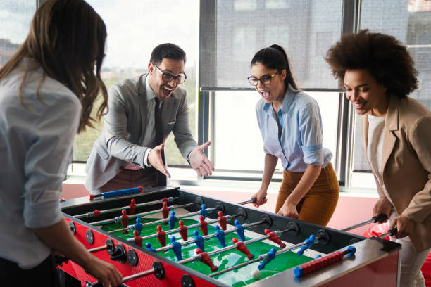 istock Coworkers playing table football on break from work 1285936919