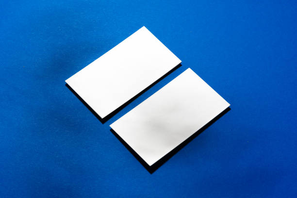 istock Two stacks of blank businesscards on blue background 1285939623
