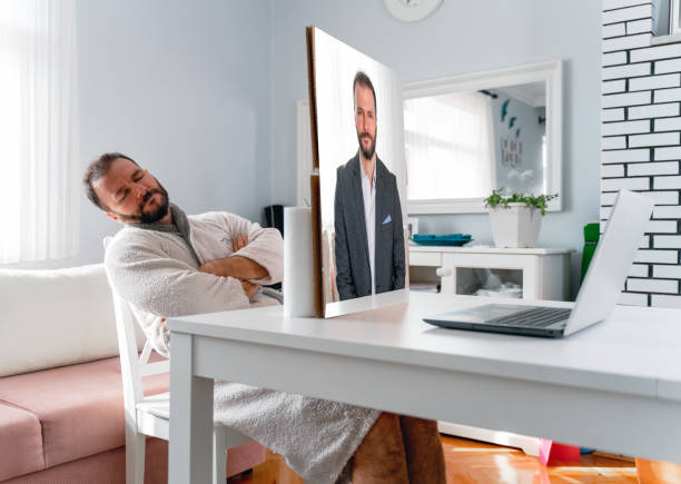 man who did not attend the meeting with the setup he set up during a business meeting man who did not attend the meeting with the setup he set up during a business meeting bathrobe photos stock pictures, royalty-free photos & images