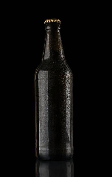 istock Beer bottle close up on black background 1285940673