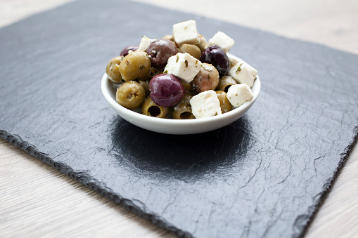 Small dish of green and Kalamata olives with cubes of feta cheese