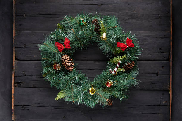 istock Christmas wreath on black wooden background 1285940994