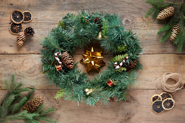 istock Christmas wreath on wooden background 1285941337