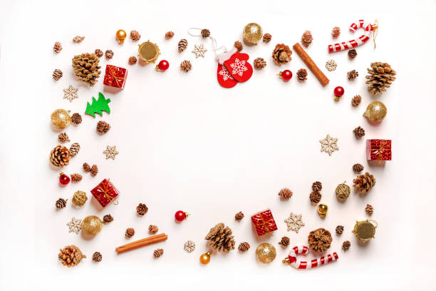 istock Christmas frame background. Christmas tree toys and decorations are arranged in a circle on a white table. Space for text 1285943664