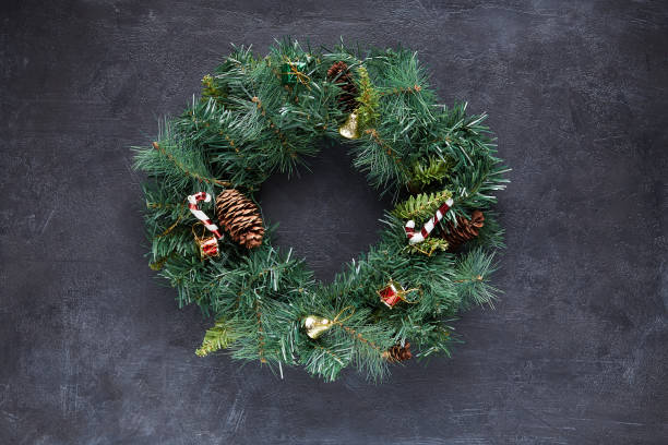 istock Christmas wreath on black concrete background 1285944537