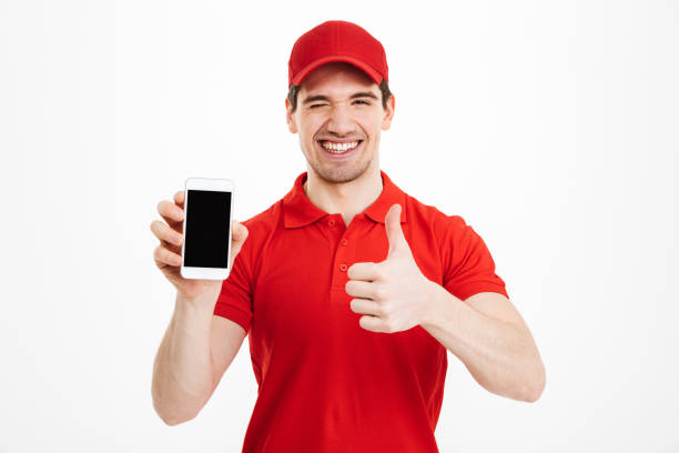 istock Excited happy young delivery man make thumbs up gesture. 1285945604