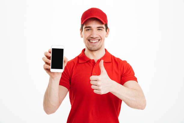 istock Excited happy young delivery man make thumbs up gesture. 1285945636