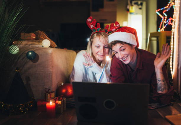 istock Couple Celebrating Christmas And New Year's Eve At Home Using Technology 1285945662