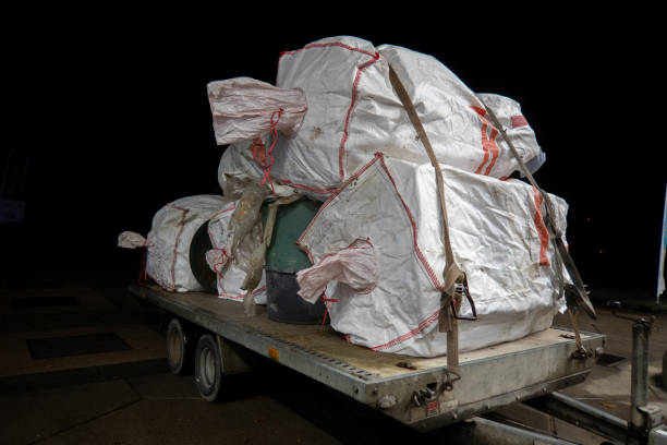 istock on  car trailer is a large load of white waste bags plastic garbage cans 1285947885