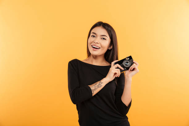 istock Cheerful young woman photographer 1285951559