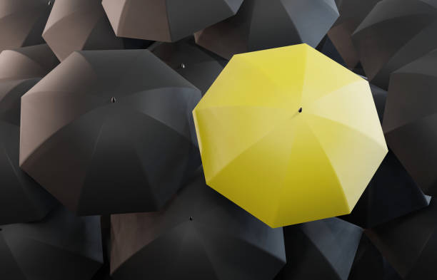 istock Yellow umbrella among black umbrellas. 1285951760