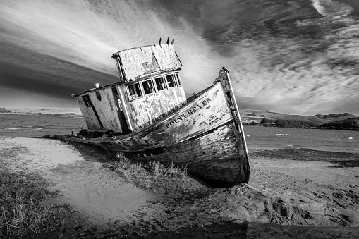 The S.S. Point Reyes run aground on sandbar at Inverness, CA with dramatic sky