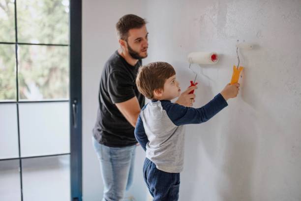 istock Father and son painting the walls 1285952994
