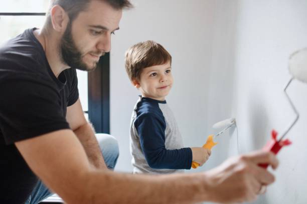istock Father and son having fun painting their house 1285953015