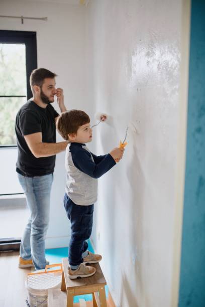 istock Father and son painting the walls 1285953031