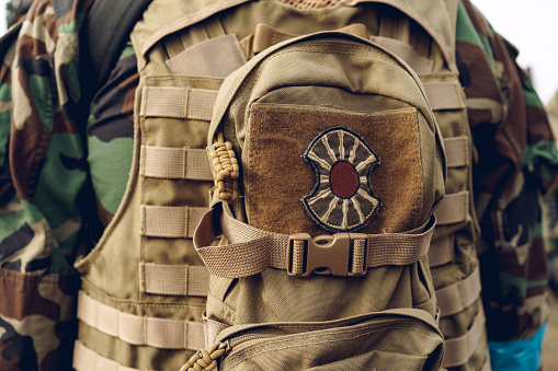 Military backpack with a patch stitched on the outside close up