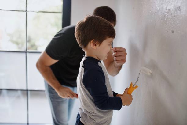 istock Father and son having fun painting their house 1285953068